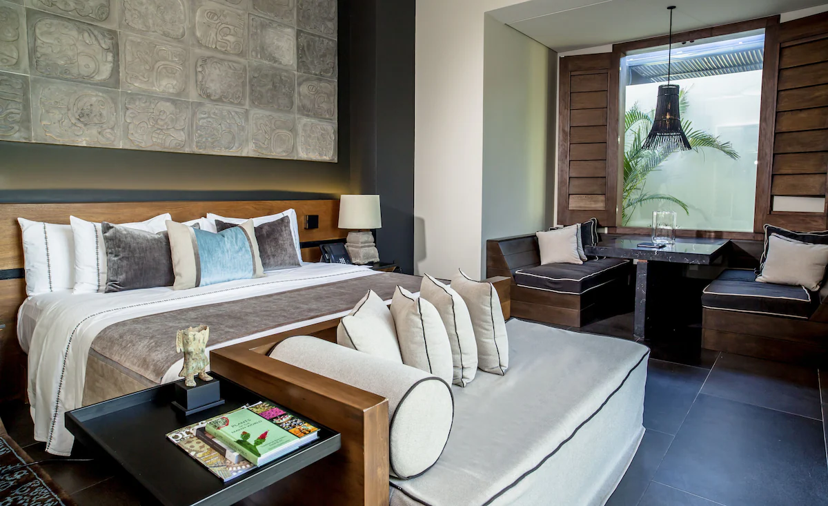 Guest room with king bed and daybed at NIZUC Resort & Spa
